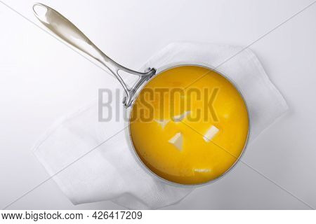 Butter In A Metal Saucepan For Cooking Ghee. Light Background.