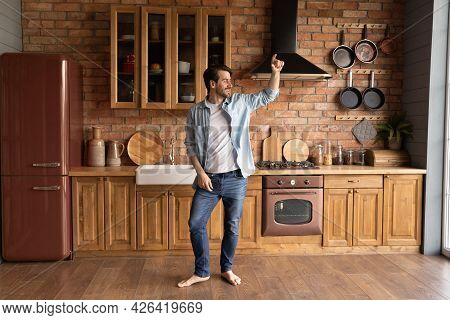 Happy Joyful Millennial Home Owner Celebrating New Apartment Buying