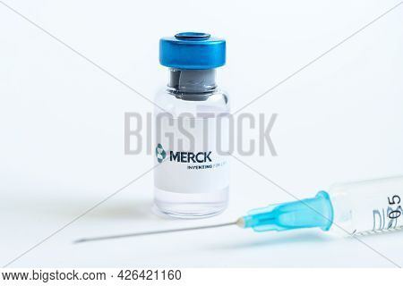 Vials Of Liquid On A White Table And The Logo Merck, Large Pharmaceutical Company. March 15, 2021. B