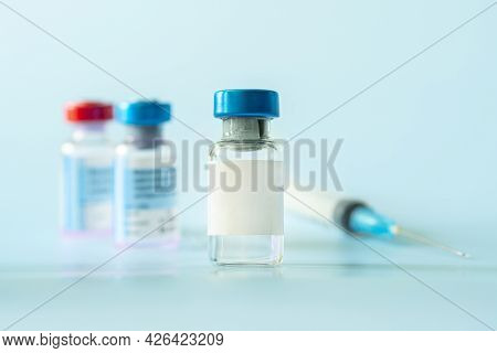 Healthcare And Pharmaceutical Drugs Concept With Syringe And Vaccine Vial With Liquid. Drug Vial Has