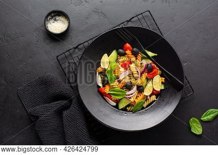 Whole Grain Pasta With Vegetables On A White Plate On Black Slate, Stone Or Concrete Background. Top