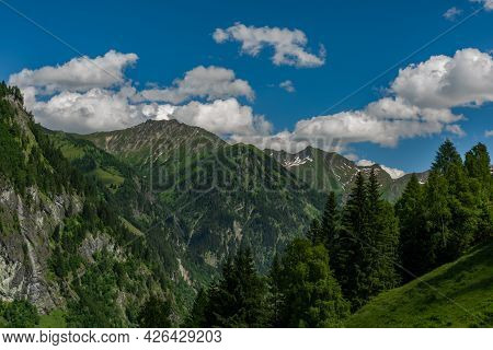 Summer Valley With Grossarler Ache Small River And Blue Cloudy Sky