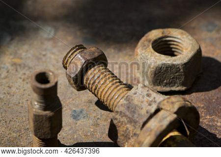 Old Rusty Bolt, Iron Rod With Screw Threads. Rusted Mechanical Components. Threaded Bolt And Nut. Di