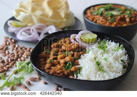 Red Kidney Beans In A Thick And Spicy Gravy Of Onions And Tomatoes Served Along With Steamed Basmati