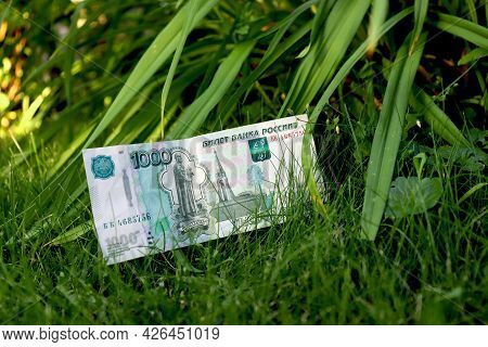 Green Money On A Green Background. Banknote One Thousand Russian Rubles. Cash Paper Money On A Backg