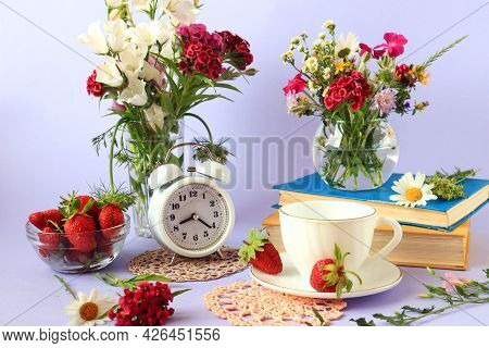 The Concept Of Good Morning And Good Mood. Books, A Cup Of Tea, Wild Flowers In Vases, Strawberries 