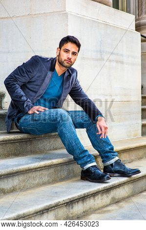 Dressing In A Dark Purple Woolen Blazer,  Blue Jeans And Black Leather Shoes, A Young Middle Eastern