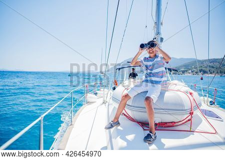 Little Boy On Board Of Sailing Yacht On Summer Cruise. Travel Adventure, Yachting With Child On Fami