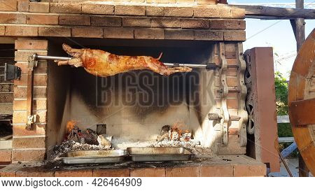 Spit Roasted Lambs, Traditional Way Of Roasting Lambs On A Rotisserie Spit In Bulgaria. Cheverme..
