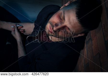 Overdosed Drug Addicted Man Near Brick Wall