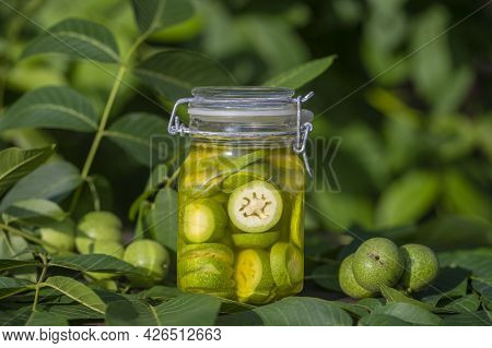 Sliced Unripe Walnuts In Alcohol In A Jar, To Prepare Homemade Tincture, Close Up. Tincture Of Green