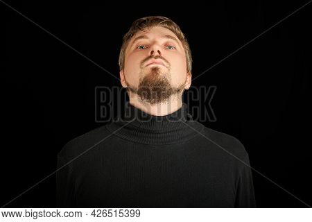 Cute Bearded Man, Threw Head Back, Black Background. Young Guy In Black Polo Neck Sweater. Confident
