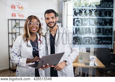 View Through The Glass Wall. Pleasant Team Of Multiethnic Doctors Scientists, Afro-american Lady And