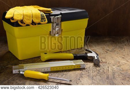Construction tools and toolbox on wooden tablel background texture. Tools kit and tool box