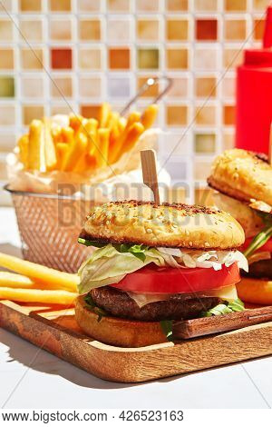 Delicious Homemade Burgers On Wooden Tray In Bright Sunlight. Burgers With Veal Cutlet, Pamidor, Che