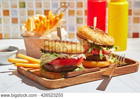 Delicious Homemade Burgers On Wooden Tray In Bright Sunlight. Burgers With Veal Cutlet, Pamidor, Che