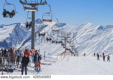 Georgia, Gudauri, March 8, 2013: Cable Car At The Ski Resort. Against The Background Of Snow-capped 