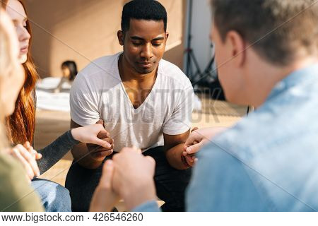 Group Of Young Diverse Multiethnic People Holding Hands Together During The Psychological Therapy, M