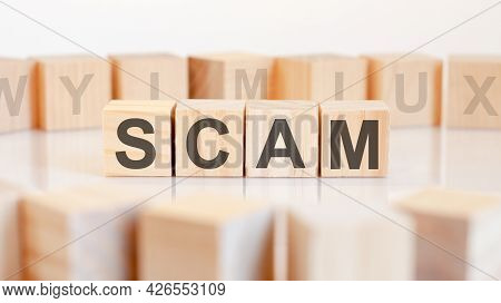 Scam - Word On Wooden Cubes On White Background