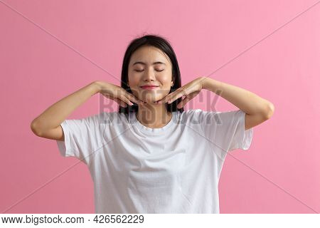 Close Up Portrait Of Young Asian Woman Doing Facebuilding Yoga Face Gymnastics Yoga Massage.