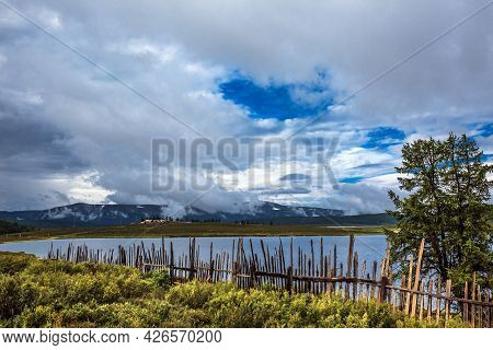 Uzunkel Mountain Lake Is Surrounded By Mountains And Clouds. Ulagan District Of The Altai Republic