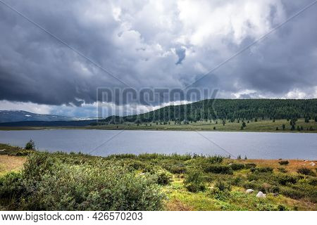 Uzunkel Mountain Lake Is Surrounded By Mountains And Clouds. Ulagan District Of The Altai Republic