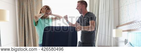 Man And Woman Are Fighting In Bedroom Near Suitcase