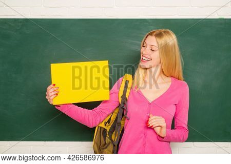 Female Student. Young Teacher Or Tutor At Classroom In School. Woman Education. Student Girl Holding