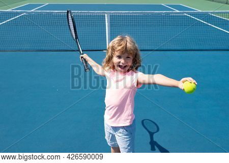 Kid Tennis Player On Tennis Court. Boy Hitting Forehand In Tennis.