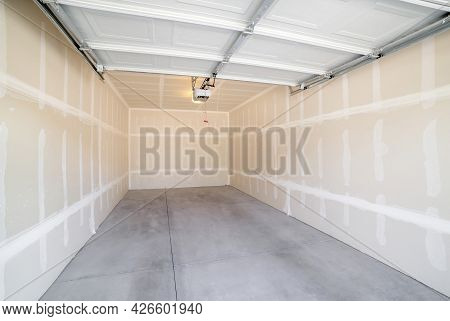 Interior Of A Detached Garage With Open Automatic Single Door