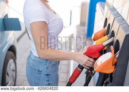 Caucasian Woman Refueling A Car At A Self-service Gas Station.