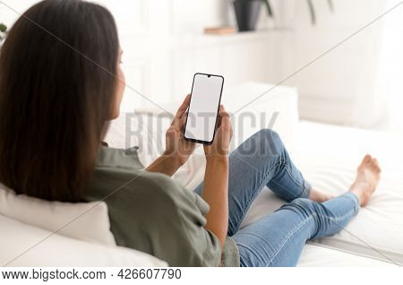 Back View Over Shoulder Of Indian Woman On The Smartphone With A Blank Empty Screen In Her Hands, Mi