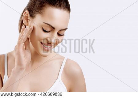Beauty Face. Smiling Woman Touching Healthy Skin Portrait. Beautiful Happy Girl Model With Fresh Fac