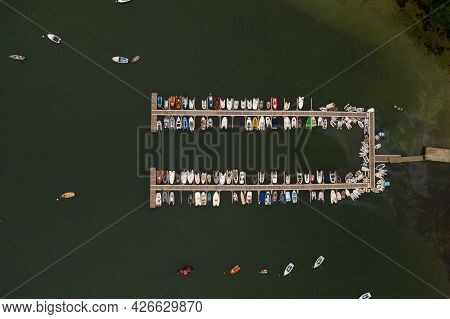 Aerial View Of A The Jetty Of A Sailing Club In Helford, Cornwall Full Of Small Boats