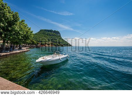 Lakeside And Beautiful Bay In Front Of The Small Town Of Garda, Tourist Resort On The Coast Of Lake 