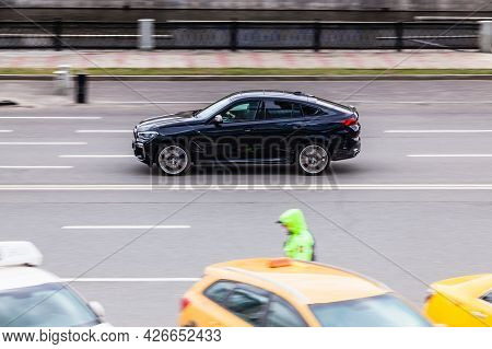 Moscow , Russia - April 2021: View Of Black Bmw X6 Driving Near Moscow City Business Center