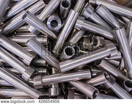 Pile Of Shiny Steel Tubes After Cnc Turning Operations - Abstract Full Frame Indistrial Background
