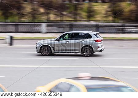 Moscow , Russia - April 14, 2020: Bmw X5 Car Driving In City With Motion Blur, View From The Side