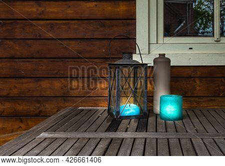 Decorative Metal Lantern With Blue Canles Glowing On Wooden Table, Vintage Stylish Design With Copy 