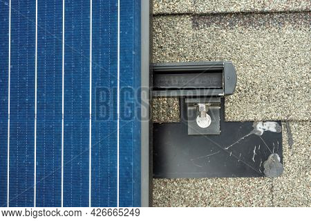 Selective Focus On Anchor Bolts Of The Last Solar Panel In A String From Directly Above.