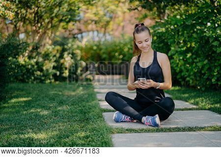 Sporty Woman Has Break For Refreshment Checks Messages And Notification Shares Content About Fitness