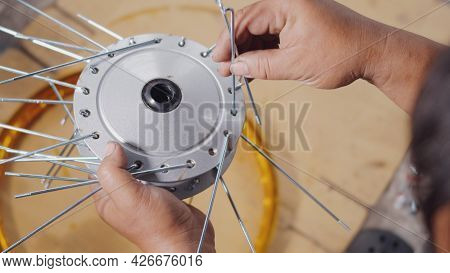 Technician Man Working Motorcycle Wheel Has Spokes Weave Up On Mechanic New Steel Wheel, Motorcycle 