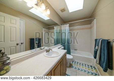 Windowless Bathroom Interior With Long Vanity Sink