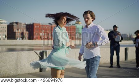 A Young Couple Dancing A Spanish Dance To Live Music. Young Couple Dancing Outdoors Under The Button