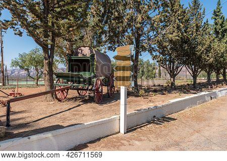 A Directional Sign And An Ox-wagon In Matjiesfontein In The Western Cape Province