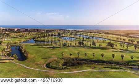 Green Golf Courses By The Sea. Salgados Beach. Portugal, Albufeira. Aerial View And High Trees, Sunn