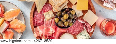 Charcuterie And Cheese Platter Panorama With Rose Wine And Salmon Sandwiches, Top Shot. A Panoramic 