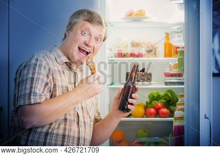 Mature Men At Fridge  With Beer And Chicken's Leg