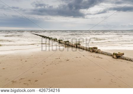 Sewage Or Waste Water Discharge Pipe Leading Out To Sea On A Beach In The Uk