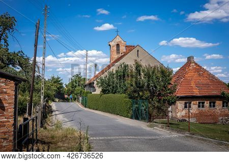 Old Church And Brick Houses In Strzegomiany Village, Sobotka, Poland, 6.07.2021.
Sunny Day, Blue Sky
